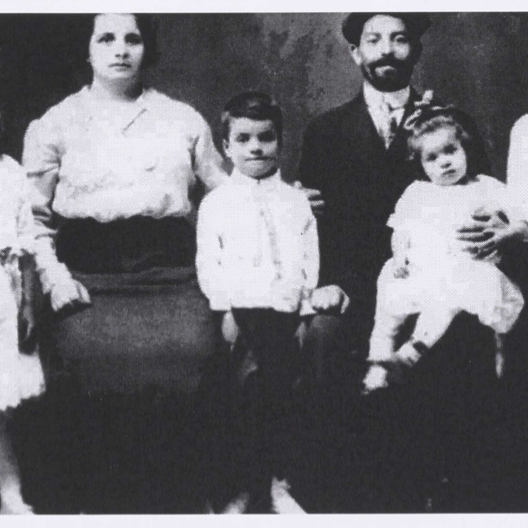 Black and white photo of a young family seated together
