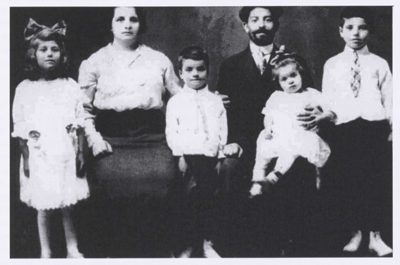 Black and white photo of a young family seated together