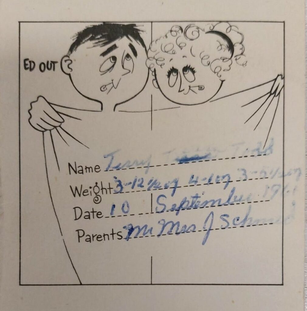 Black and white photo of a birth card with a man and a woman standing behind a sheet. The babies' information is detailed on the card such as weight, length, names, and parents names