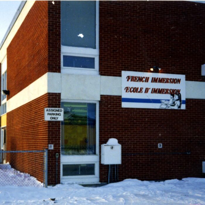 French Immersion School, 1988, Cecie Barrett Colour photo of a brick school with white trim. There is a sign on the side of the building which reads 'French Immersion Ecole D'Immersion'