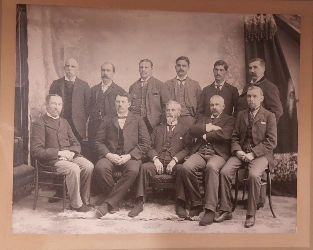Sepia-coloured photo of Selkirk Town Council seated and standing