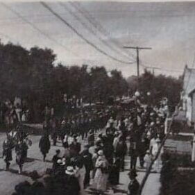 Town Hall View from Eveline Street and Eaton Avenue, c1919, Ted Wozny Black and white photo of the town hall with a parade coming down the street