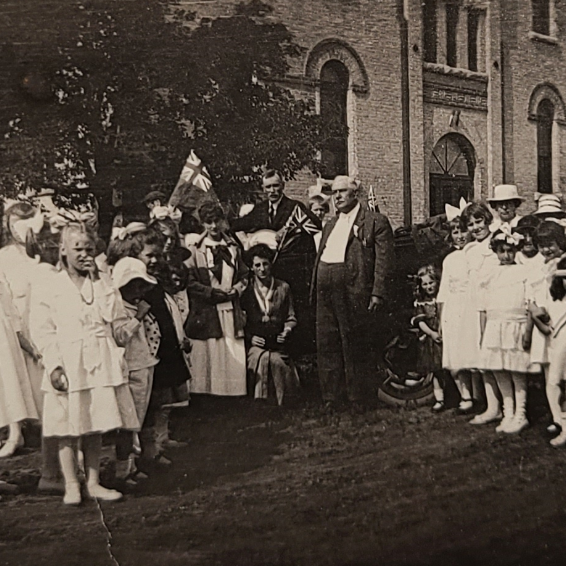 Crowd Gathered Outside of Central School, 1919, Selkirk Museum Collection Black and white photo of a group of people standing outside of Central School