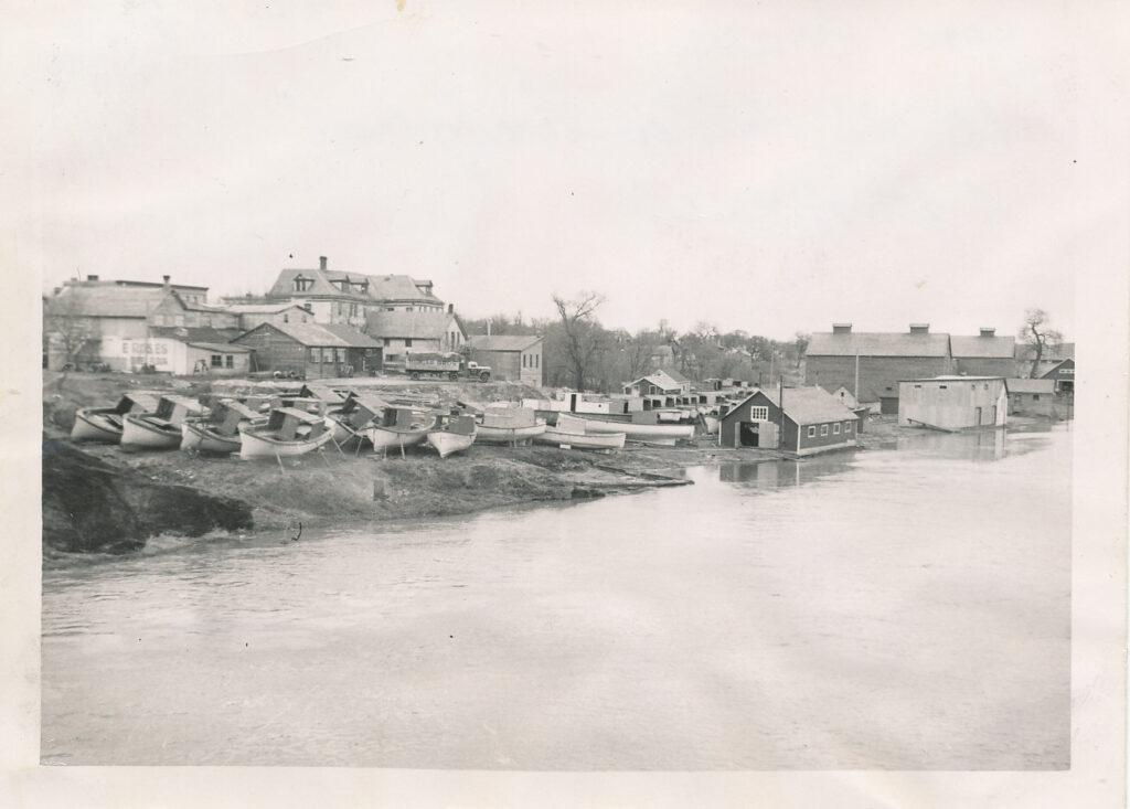 Black and white photo of Selkirk Dock, ice houses, and Booth Fisheries along the river