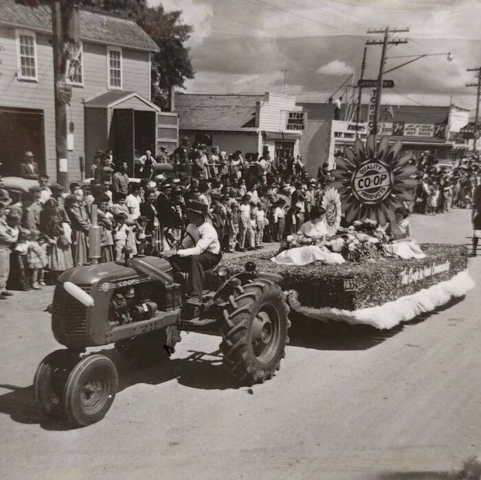 Selkirks 75th Parade Town of Selkirk Coop, 1957, Selkirk Museum Collection Black and white photo of Co-Ops parade float. There is a crowd of people standing along the road
