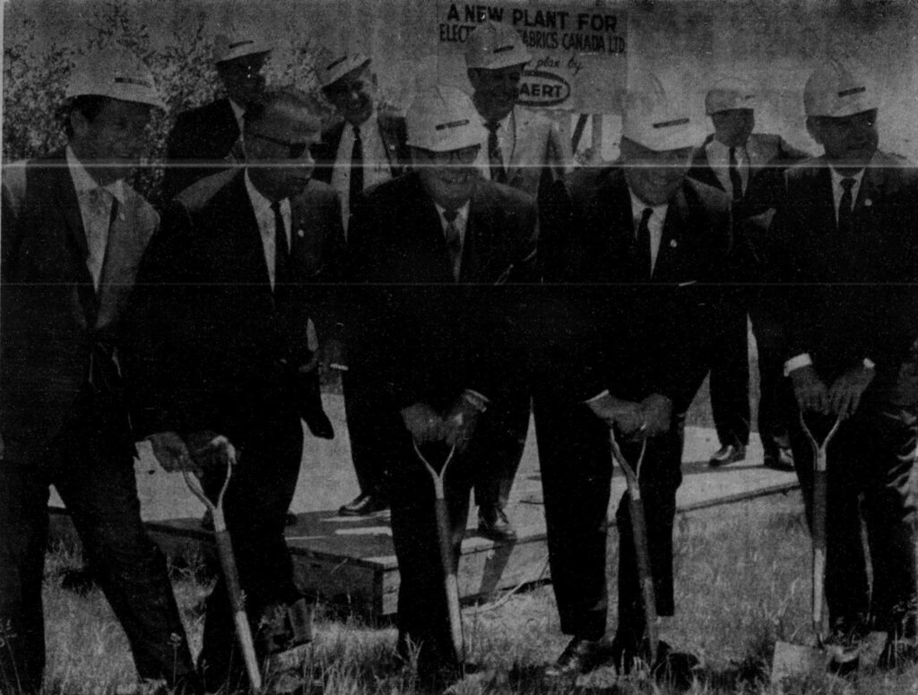 Black and white photo of a group of men working on a construction site