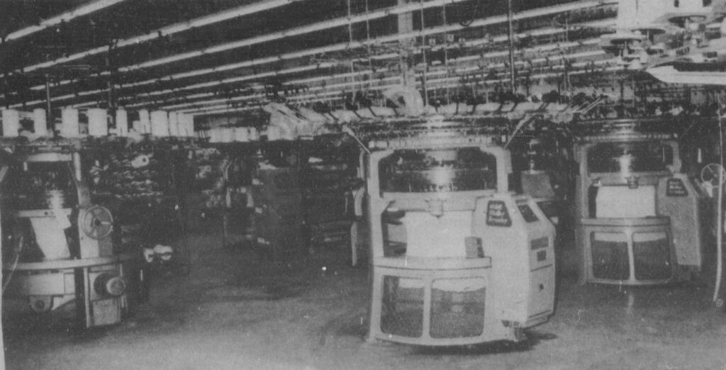Black and white photo of the inside of a fabric plant