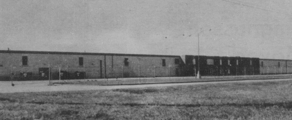 Black and white photo of a large, long, rectangular building