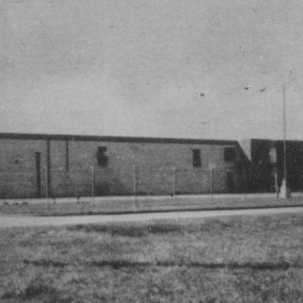Outside the Plant, 1974, Selkirk Enterprise Black and white photo of a large, long, rectangular building