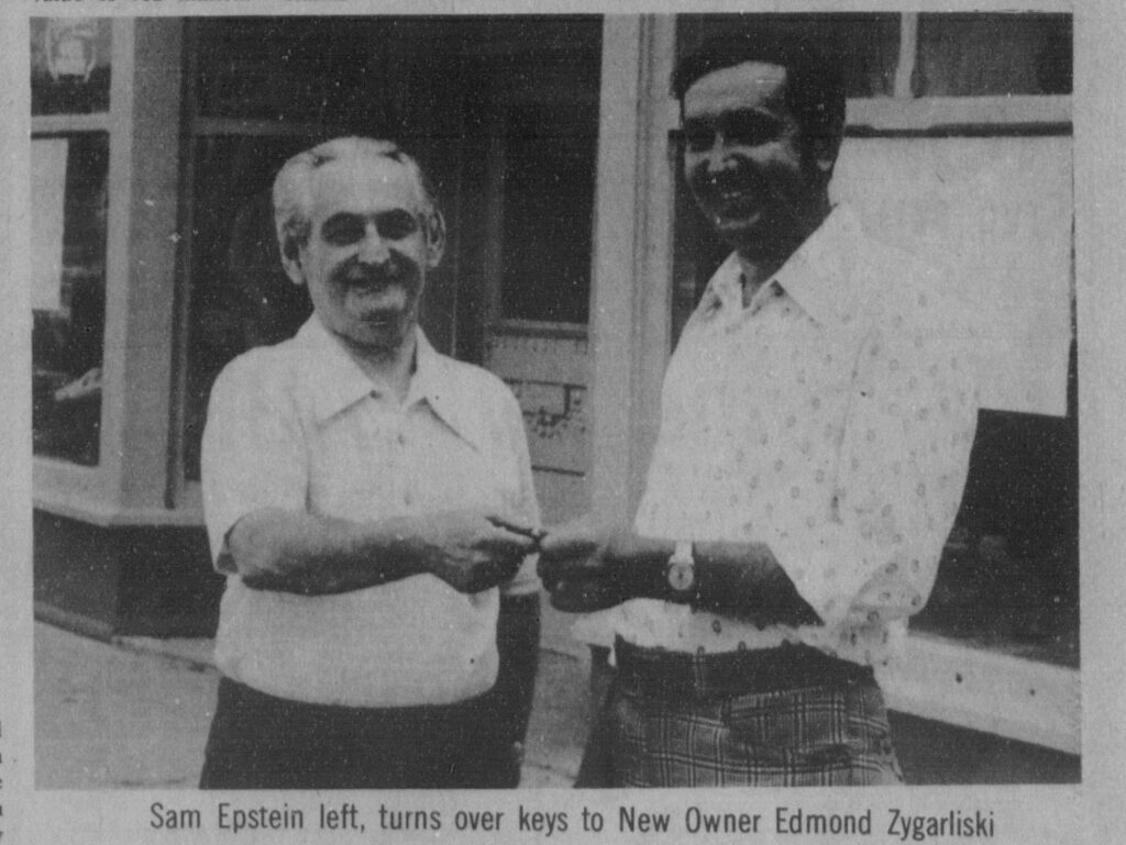 Black and white photo of Sam Epstein turning the keys over to Edmon Zygarliski